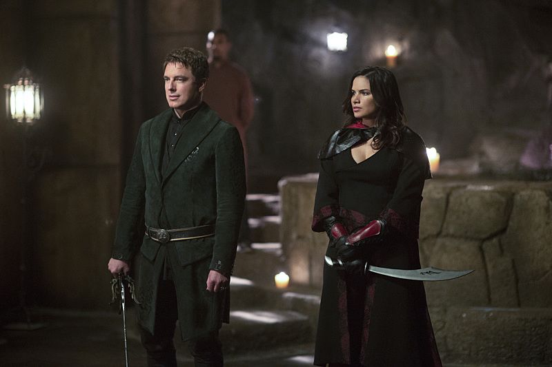 Arrow -- "Restoration" -- Image AR403B_0035b.jpg -- Pictured (L-R): John Barrowman as Malcolm Merlyn and Katrina Law as Nyssa al Ghul -- Photo: Diyah Pera /The CW -- é 2015 The CW Network, LLC. All Rights Reserved.