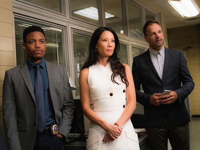 "Henny Penny the Sky is Falling" -- Captain Gregson lobbies to include Holmes and Watson when his unit is selected to receive a city commendation for its exemplary work. Also, as Holmes and Watson consult on the investigation into a financial analyst's murder, they are drawn into the world of asteroid research, on the 100th episode of ELEMENTARY, Sunday, Oct. 30 (10:00-11:00 PM, ET/PT) on the CBS Television Network. Pictured (L-R) Jon Michael Hill as Detective Marcus Bell, Lucy Liu as Joan Watson and Jonny Lee Miller as Sherlock Holmes Photo: Michael Parmelee/CBS é2016 CBS Broadcasting, Inc. All Rights Reserved