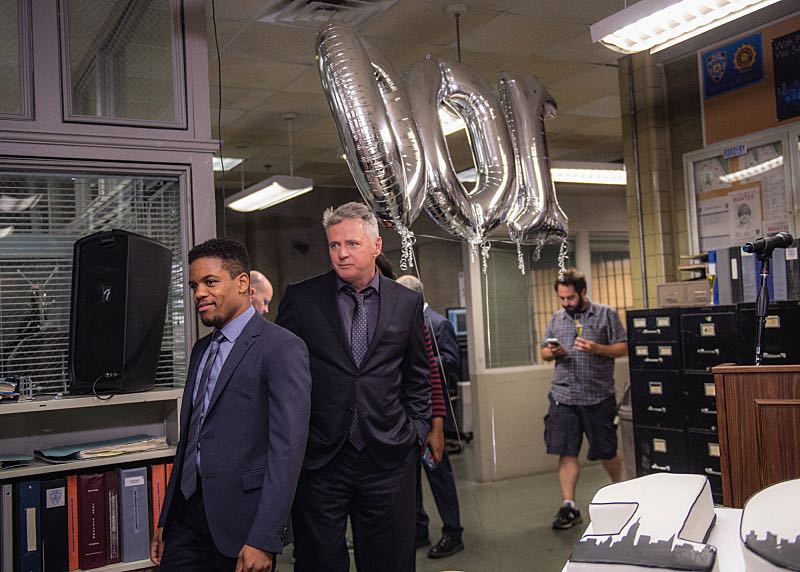 "Henny Penny The Sky Is Falling" -- The cast of ELEMENTARY celebrates their milestone 100th episode with a cake-cutting ceremony Pictured (L-R) Jon Michael Hill and Aidan Quinn Photo: Michele Crowe /CBS é2016 CBS Broadcasting Inc. All Rights Reserved.