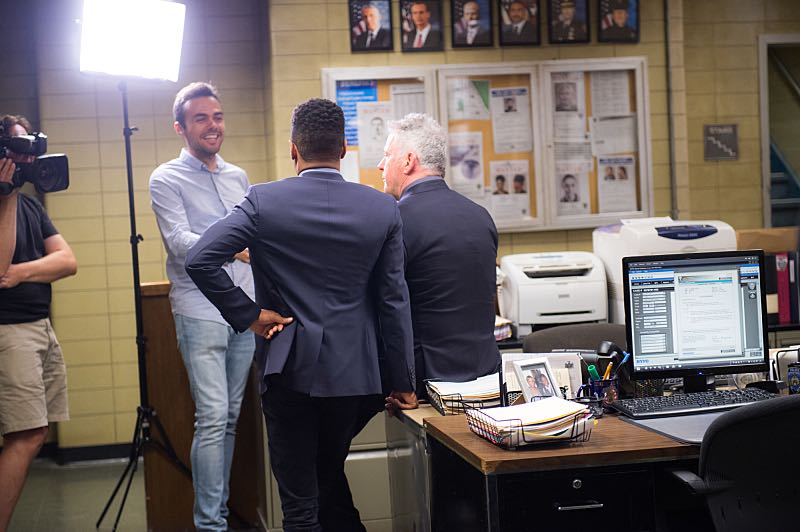 "Henny Penny The Sky Is Falling" -- The cast of ELEMENTARY celebrates their milestone 100th episode with a cake-cutting ceremony Pictured (L-R) Jon Michael Hill and Aidan Quinn Photo: Michele Crowe /CBS é2016 CBS Broadcasting Inc. All Rights Reserved.