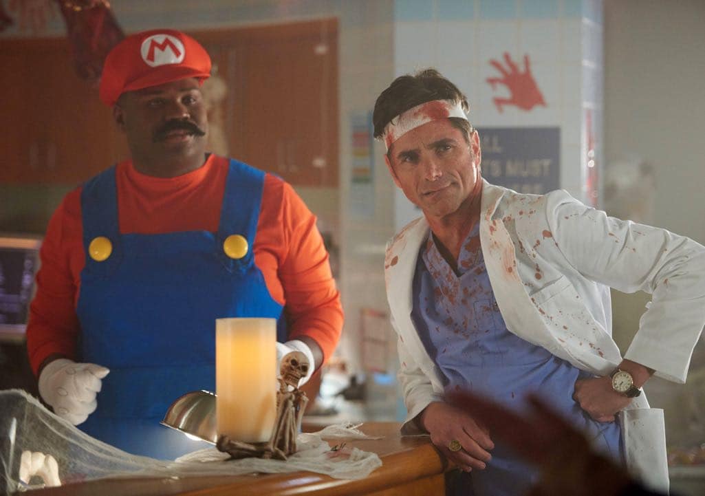 SCREAM QUEENS: L-R: James Earl and John Stamos in the all-new “Halloween Blues” episode of SCREAM QUEENS airing Tuesday, Oct. 18 (9:01-10:00 PM ET/PT) on FOX. Cr: Michael Becker / FOX. © 2016 FOX Broadcasting Co.