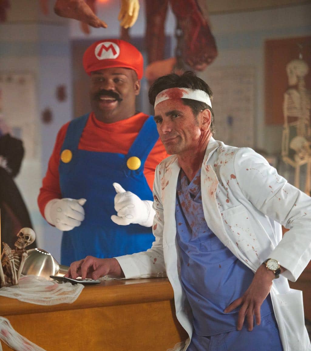 SCREAM QUEENS: L-R: James Earl and John Stamos in the all-new “Halloween Blues” episode of SCREAM QUEENS airing Tuesday, Oct. 18 (9:01-10:00 PM ET/PT) on FOX. Cr: Michael Becker / FOX. © 2016 FOX Broadcasting Co.