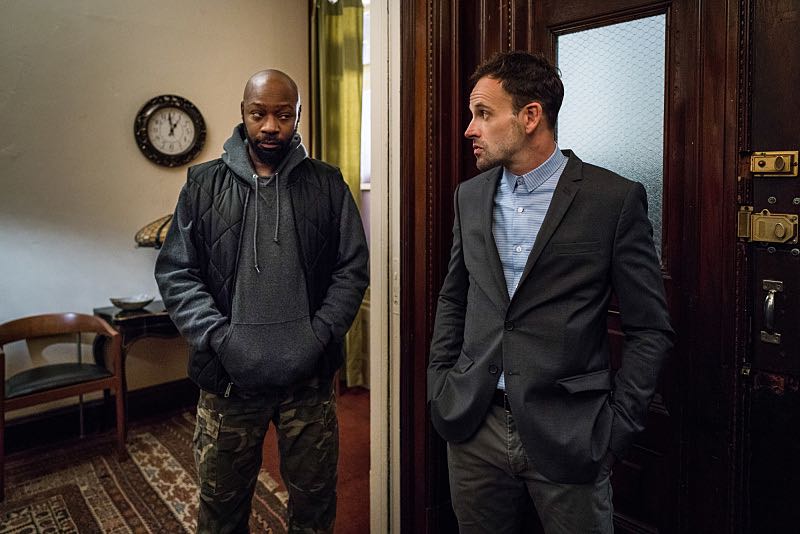 Elementary Nelsan Ellis as Shinwell Johnson and Jonny Lee Miller as Sherlock Holmes "It Serves You Right to Suffer" -- When Shinwell comes to Holmes and Watson for help after he's framed for a gang killing, they have three days to find the real murderer before he is arrested and sent back to jail, on ELEMENTARY, Sunday, Dec. 11 (10:00-11:00 PM, ET/PT) on the CBS Television Network. The episode was directed by series star Aidan Quinn, in his television directorial debut. Pictured (L-R) Nelsan Ellis as Shinwell Johnson and Jonny Lee Miller as Sherlock Holmes Photo: Michael Parmelee/CBS é2016 CBS Broadcasting, Inc. All Rights Reserved