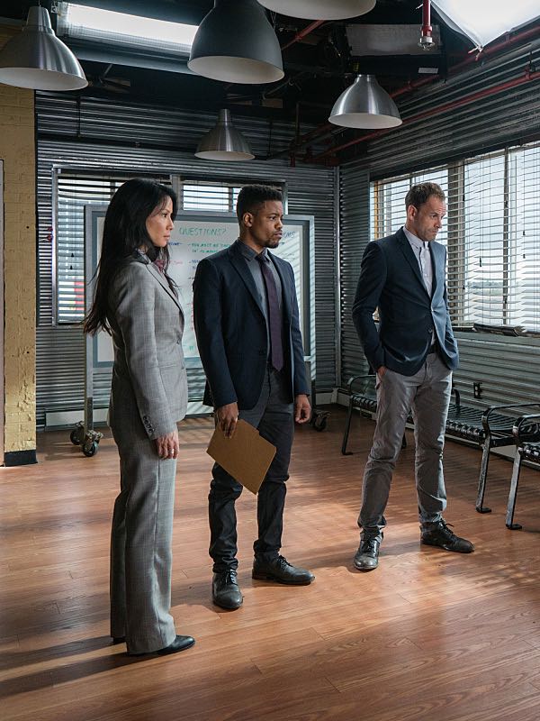 Elementary "Bang Bang Shoot Chute" Pictured (L-R) Lucy Liu as Joan Watson , Jon Michael Hill as Detective Marcus Belll, and Jonny Lee Miller as Sherlock Holmes "Bang Bang Shoot Chute" -- Holmes and Watson search for two murderers after a base jumper is shot out of the sky by one killer, and has his parachute sabotaged by another. Also, after Joan's sister, Lin (Samantha Quan), thinks she sees Shinwell with a member of his old gang, Joan takes drastic measures to make sure he won't be drawn back into a life of crime, on ELEMENTARY, Sunday, Nov. 20 (10:30-11:30 PM, ET/10:00-11:00 PM, PT) on the CBS Television Network. Pictured (L-R) Lucy Liu as Joan Watson , Jon Michael Hill as Detective Marcus Belll, and Jonny Lee Miller as Sherlock Holmes Photo: Michael Parmelee/CBS é2016 CBS Broadcasting, Inc. All Rights Reserved