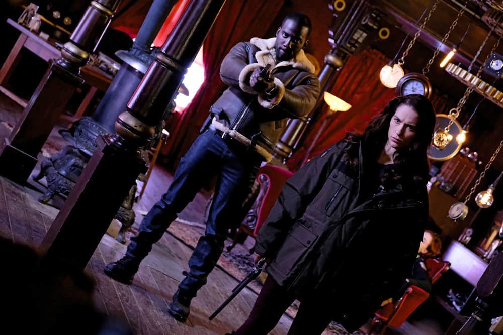 WYNONNA EARP -- "Whiskey Lullaby" Episode 206 -- Pictured: (l-r) Shamier Anderson as Agent Dolls, Melanie Scrofano as Wynonna Earp -- (Photo by: Michelle Faye/Syfy/Wynonna Earp Season 2) WYNONNA EARP -- "Whiskey Lullaby" Episode 206 -- Pictured: (l-r) Shamier Anderson as Agent Dolls, Melanie Scrofano as Wynonna Earp -- (Photo by: Michelle Faye/Syfy/Wynonna Earp Season 2)