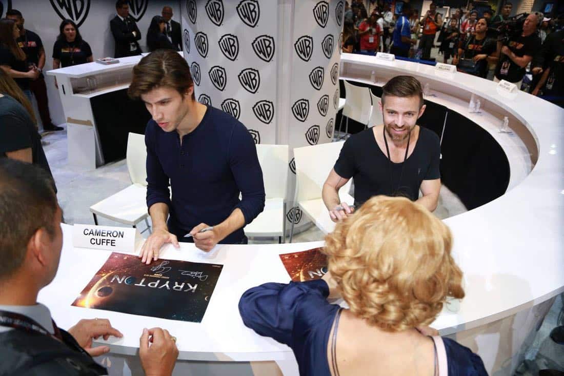 KRYPTON star Cameron Cuffe (left) and executive producer Cameron Welsh sign autographs for fans at the Warner Bros. booth at Comic-Con 2017 on Saturday, July 22. #WBSDCC (© 2017 WBEI. All Rights Reserved) KRYPTON star Cameron Cuffe (left) and executive producer Cameron Welsh sign autographs for fans at the Warner Bros. booth at Comic-Con 2017 on Saturday, July 22. #WBSDCC (© 2017 WBEI. All Rights Reserved)