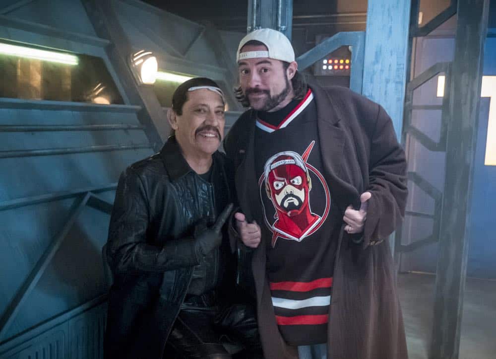 The Flash -- "Null and Annoyed" -- Image Number: FLA417a_BTS_0356b.jpg -- Pictured (L-R): Behind the scenes with Kevin Smith and Danny Trejo -- Photo: Katie Yu/The CW -- é 2018 The CW Network, LLC. All rights reserved