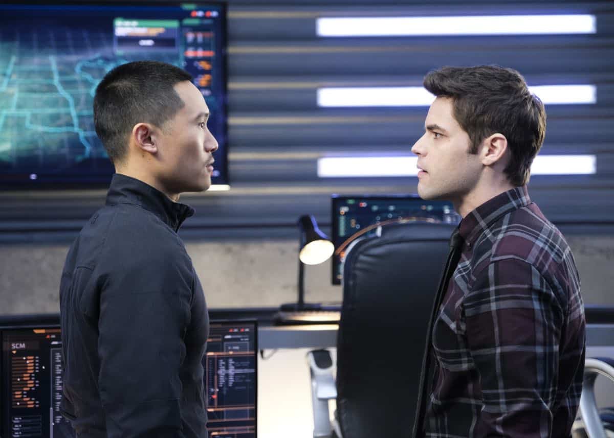 Supergirl -- "In Search of Lost Time" -- Image Number: SPG315a_0290.jpg -- Pictured (L-R): Curtis Lum as Agent Demos and Jeremy Jordan as Winn -- Photo: Robert Falconer/The CW -- é 2018 The CW Network, LLC. All Rights Reserved.