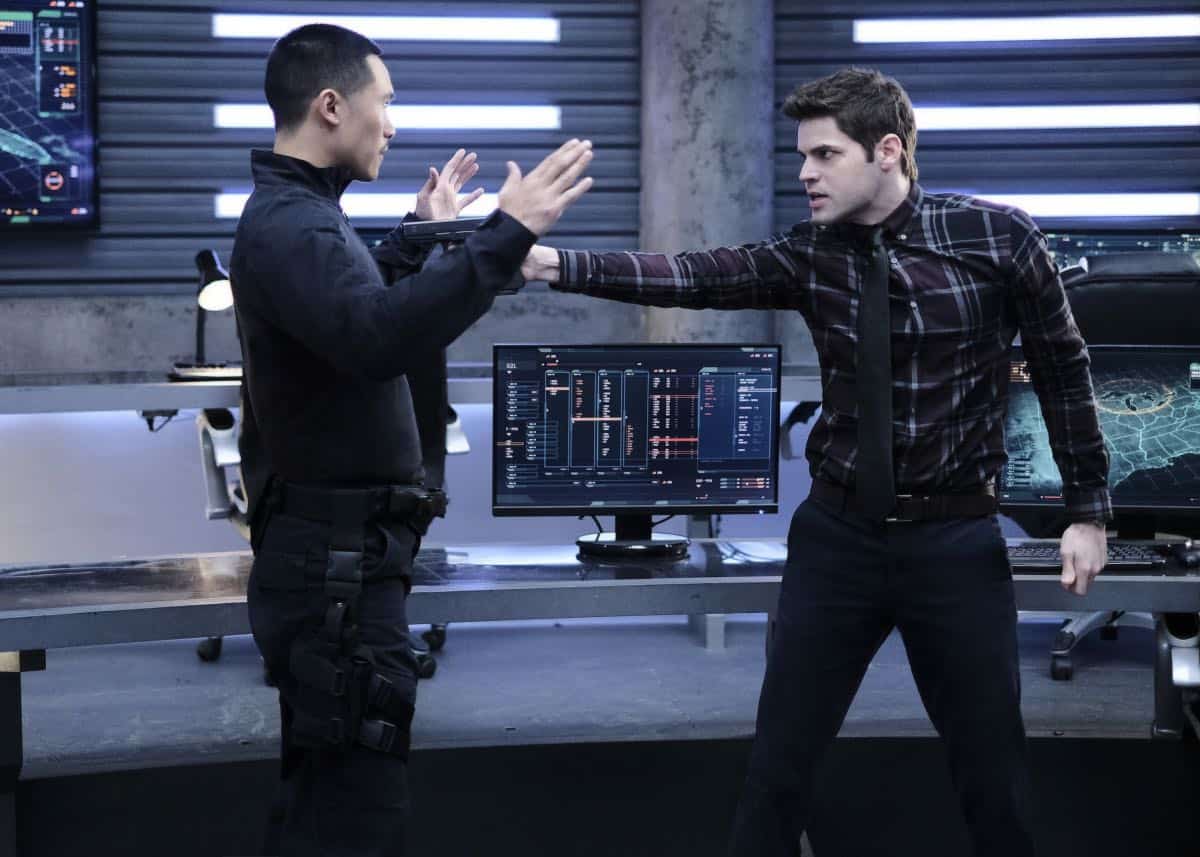 Supergirl -- "In Search of Lost Time" -- Image Number: SPG315a_0334.jpg -- Pictured (L-R): Curtis Lum as Agent Demos and Jeremy Jordan as Winn -- Photo: Robert Falconer/The CW -- é 2018 The CW Network, LLC. All Rights Reserved.