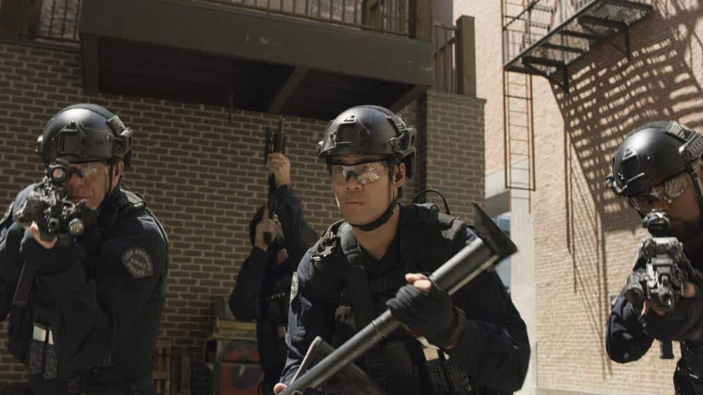 "Shaky Town" -- The SWAT team engages in a standoff with human traffickers holding child hostages when a major earthquake hits Los Angeles during their operation and compromises the takedown. Also, while Hondo forms an unexpected personal connection with Deputy District Attorney Nia Wells (Nikiva Dionne), Jim Street has trouble adjusting to his new life as a patrol officer, on the second season premiere of S.W.A.T., Thursday, Sept. 27 (10:00-11:00 PM, ET/PT) on the CBS Television Network. Pictured L toR : Kenny Johnson as Dominique Luca, David Lim as Victor Tan and Shemar Moore as Daniel "Hondo" Harrelson. Photo: Screengrab/CBS é2018 CBS Broadcasting, Inc. All Rights Reserved