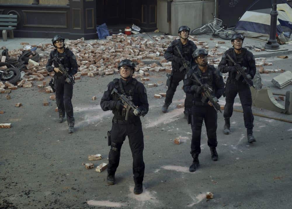 "Shaky Town" -- The SWAT team engages in a standoff with human traffickers holding child hostages when a major earthquake hits Los Angeles during their operation and compromises the takedown. Also, while Hondo forms an unexpected personal connection with Deputy District Attorney Nia Wells (Nikiva Dionne), Jim Street has trouble adjusting to his new life as a patrol officer, on the second season premiere of S.W.A.T., Thursday, Sept. 27 (10:00-11:00 PM, ET/PT) on the CBS Television Network. Pictured L to R: Lina Esco as Christina "Chris" Alonso, Kenny Johnson as Dominique Luca, Shemar Moore as Daniel "Hondo" Harrelson and David Lim as Victor Tan. Photo: Screengrab/CBS é2018 CBS Broadcasting, Inc. All Rights Reserved