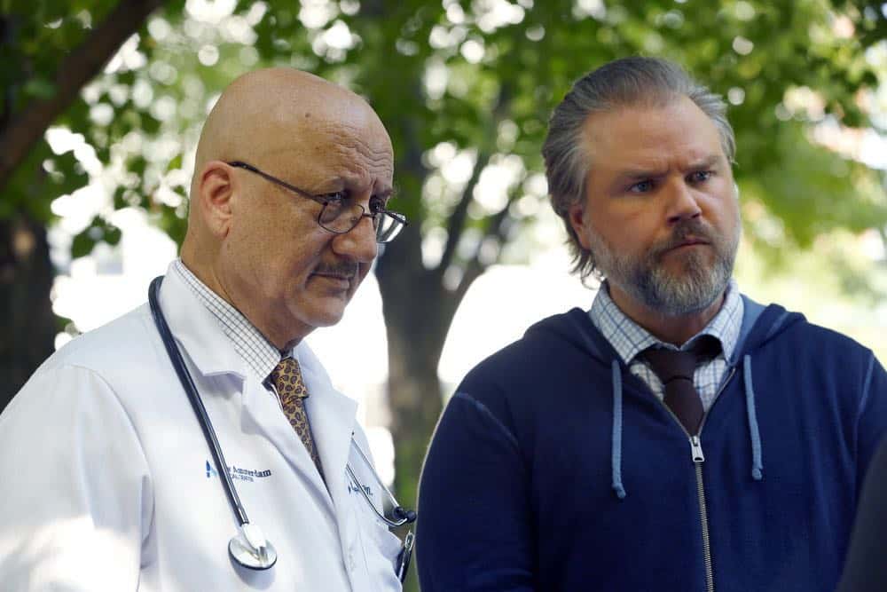 NEW AMSTERDAM -- "Rituals" Episode 102 -- Pictured: (l-r) Anupam Kher as Dr. Vijay Kapoor, Tyler Labine as Dr. Iggy Frome -- (Photo by: Will Hart/NBC)