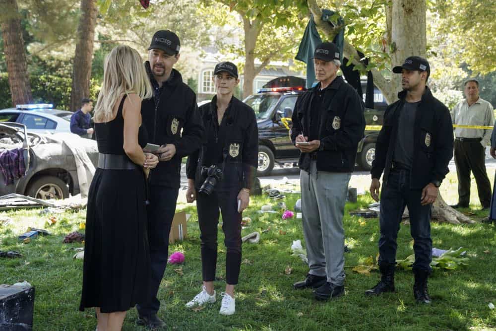 "Boom" -- One of the NCIS agents is starstruck after the team investigates an explosion outside the home of Navy Petty Officer First Class Todd Nicholas (Cameron Radice) and his wife, popular reality TV star Sheba Nicholas (Tara Holt). Also, Vance continues physical therapy for the injuries sustained when he was held hostage, on NCIS, Tuesday, Oct. 9 (8:00-9:00 PM, ET/PT) on the CBS Television Network. Pictured: Tara Holt, Sean Murray, Emily Wickersham, Mark Harmon, Wilmer Valderrama. Photo: Sonja Flemming/CBS é2018 CBS Broadcasting, Inc. All Rights Reserved