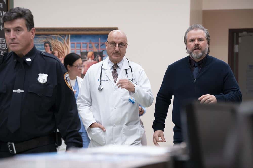 NEW AMSTERDAM -- "Every Last Minute" Episode 103 -- Pictured: (l-r) Anupam Kher as Dr. Vijay Kapoor, Tyler Labine as Dr. Iggy Frome -- (Photo by: Virginia Sherwood/NBC)