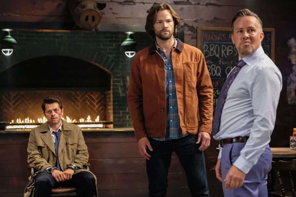 Supernatural -- "Stranger in a Strange Land" -- Image Number: SN1401b_0051b.jpg -- Pictured (L-R): Misha Collins as Castiel, Jared Padalecki as Sam and Dean Armstrong as Kip -- Photo: Bettina Strauss/The CW -- é 2018 The CW Network, LLC All Rights Reserved Supernatural -- "Stranger in a Strange Land" -- Image Number: SN1401b_0051b.jpg -- Pictured (L-R): Misha Collins as Castiel, Jared Padalecki as Sam and Dean Armstrong as Kip -- Photo: Bettina Strauss/The CW -- é 2018 The CW Network, LLC All Rights Reserved