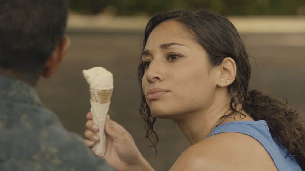 "Mimiki ke kai, ahuwale ka papa leho" -- Crime spikes when a heat wave hits Oahu, causing McGarrett and Danny to hunt down a bank thief, and Tani and Junior's car is stolen while they're on duty. Also, Grover plays the golf game of a lifetime, and Kamekona incites a riot by price-gouging on his shave ice, on HAWAII FIVE-0, Friday, Oct. 12 (9:00-10:00 PM, ET/PT) on the CBS Television Network. Pictured: Meaghan Rath as Tani Rey. Photo: Screengrab/CBS é2018 CBS Broadcasting, Inc. All Rights Reserved ("Mimiki ke kai, ahuwale ka papa leho" is Hawaiian for "When the Sea Draws Out the Tidal Wave, the Rocks Where the Cowries Hide Are Exposed")
