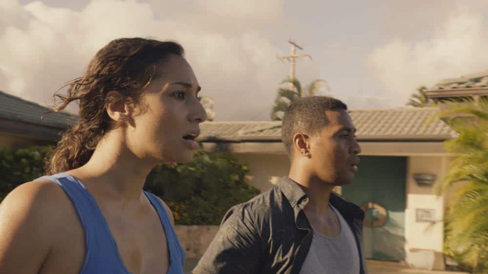 "Mimiki ke kai, ahuwale ka papa leho" -- Crime spikes when a heat wave hits Oahu, causing McGarrett and Danny to hunt down a bank thief, and Tani and Junior's car is stolen while they're on duty. Also, Grover plays the golf game of a lifetime, and Kamekona incites a riot by price-gouging on his shave ice, on HAWAII FIVE-0, Friday, Oct. 12 (9:00-10:00 PM, ET/PT) on the CBS Television Network. Pictured L to R: Meaghan Rath as Tani Rey and Beulah Koale as Junior Reigns. Photo: Screengrab/CBS é2018 CBS Broadcasting, Inc. All Rights Reserved ("Mimiki ke kai, ahuwale ka papa leho" is Hawaiian for "When the Sea Draws Out the Tidal Wave, the Rocks Where the Cowries Hide Are Exposed")