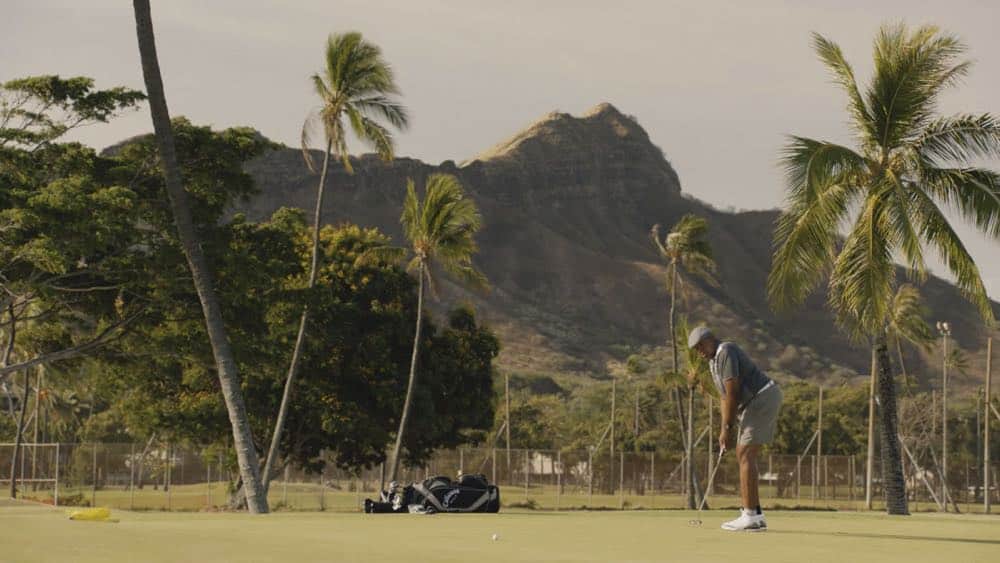 "Mimiki ke kai, ahuwale ka papa leho" -- Crime spikes when a heat wave hits Oahu, causing McGarrett and Danny to hunt down a bank thief, and Tani and Junior's car is stolen while they're on duty. Also, Grover plays the golf game of a lifetime, and Kamekona incites a riot by price-gouging on his shave ice, on HAWAII FIVE-0, Friday, Oct. 12 (9:00-10:00 PM, ET/PT) on the CBS Television Network. Pictured: Chi McBride as Lou Grover. Photo: Screengrab/CBS é2018 CBS Broadcasting, Inc. All Rights Reserved ("Mimiki ke kai, ahuwale ka papa leho" is Hawaiian for "When the Sea Draws Out the Tidal Wave, the Rocks Where the Cowries Hide Are Exposed")